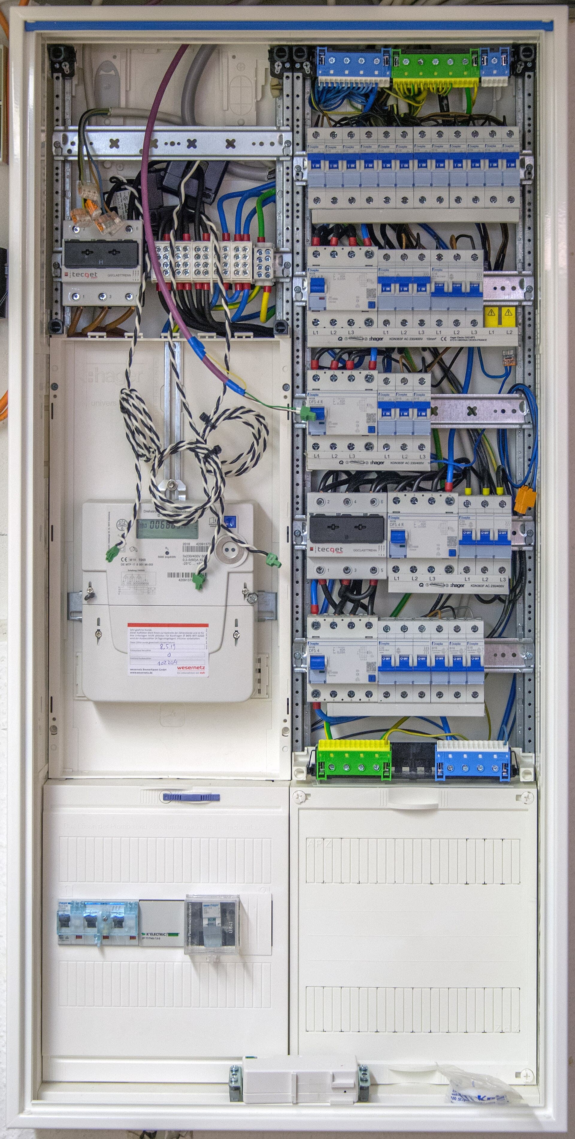 Open electrical cabinet with circuit breakers and wiring